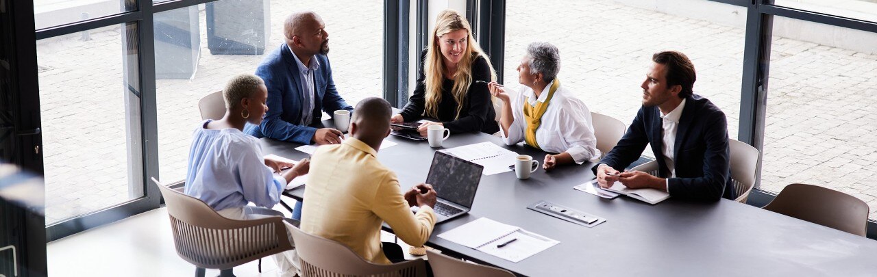 Group of colleagues conversing in a conference room