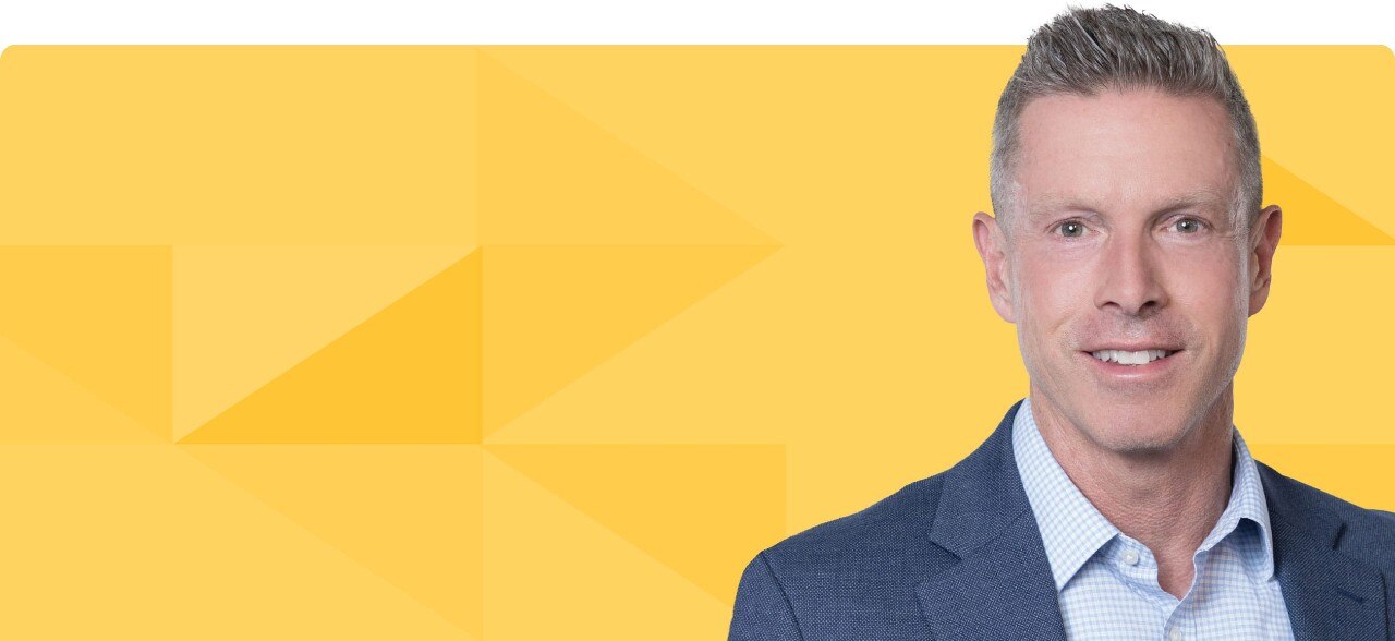 Kirk Reis's headshot on a gold tessellated background