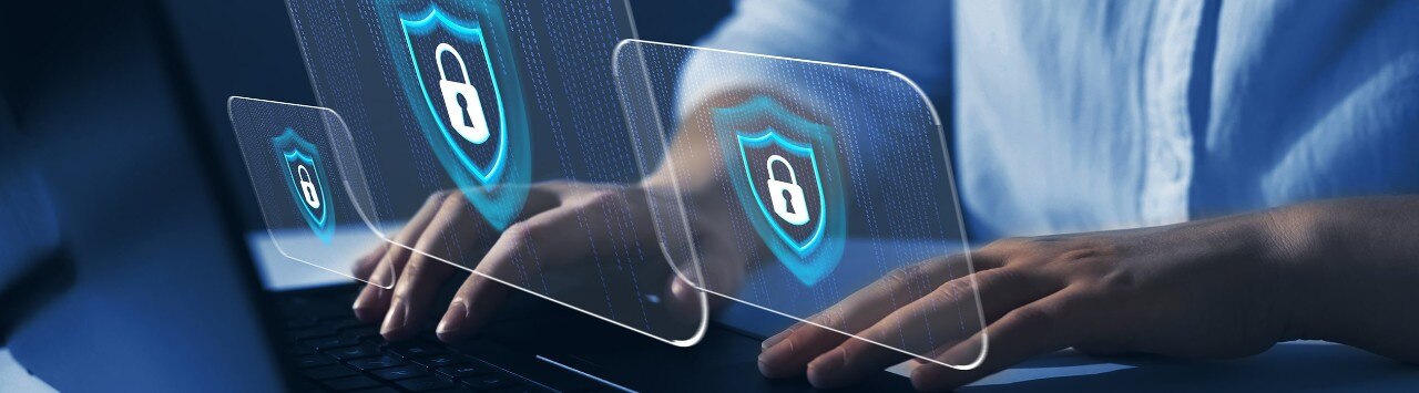 A person working on a laptop with three lock screen images in the foreground