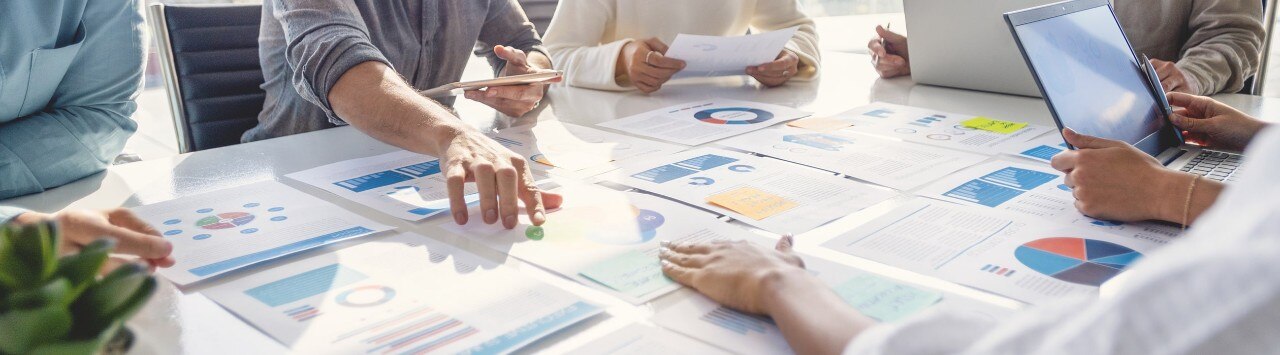 Group of colleagues reviewing financial data at conference table
