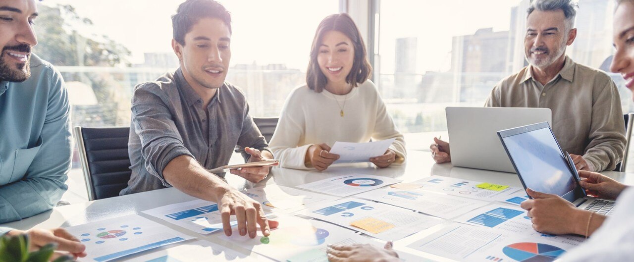 Group of colleagues reviewing financial data at conference table