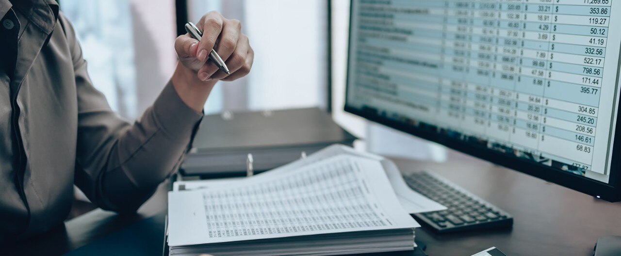 Employee looks over analytics on desktop