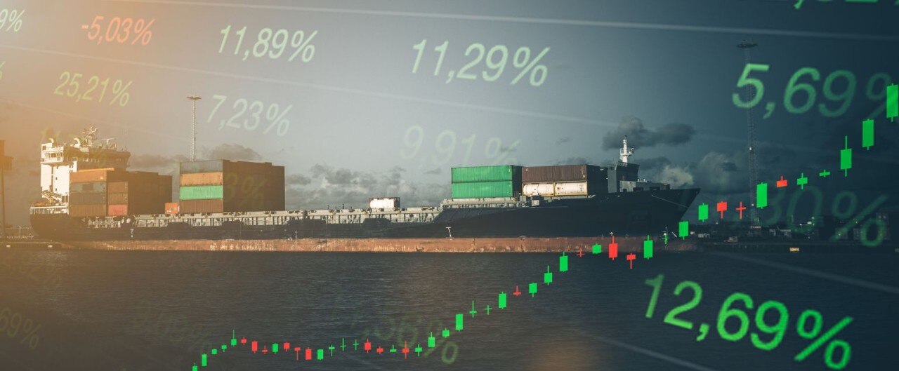 Stock charts and percentages superimposed over a wide view of fuel barges