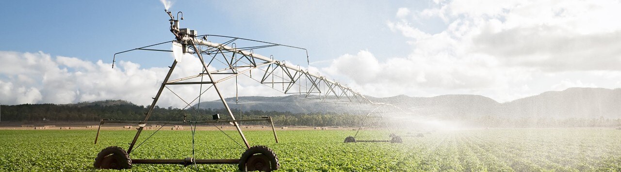 An irrigation machine spraying water on a large field