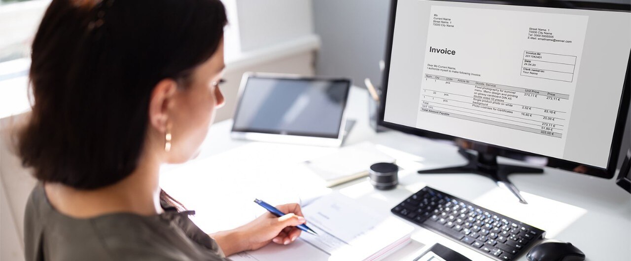 Female business owner working with accounting software for invoicing
