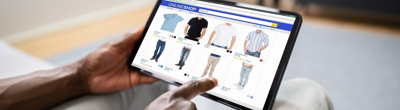 Man shopping for complementary clothing items on tablet