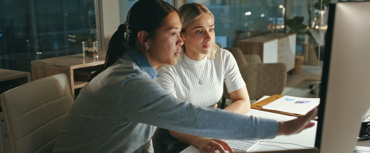 Two female business owners looking at computer monitor for security measures