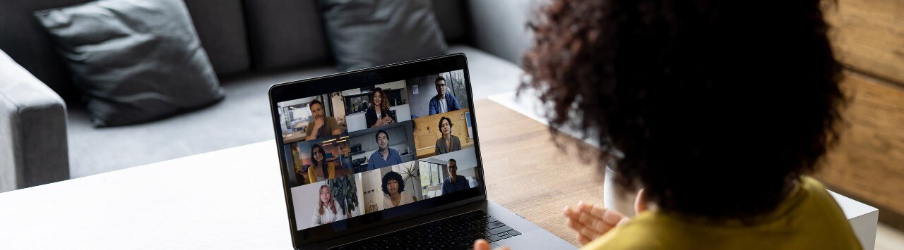 Female small business owner conducting video conference with employees
