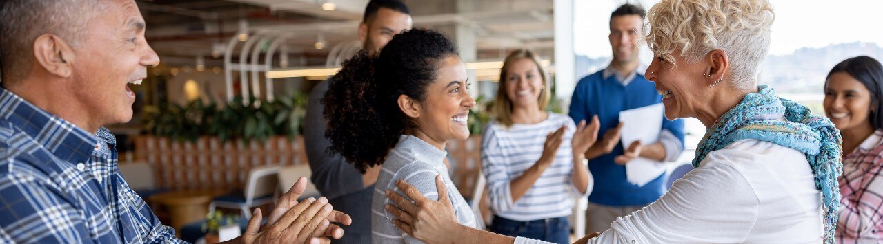Employees clapping and being recognized by manager