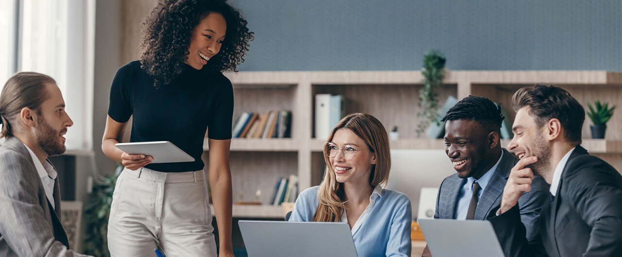 Smiling colleagues seated in conference room