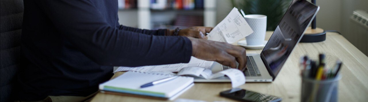 Business owner reviewing receipts while preparing taxes