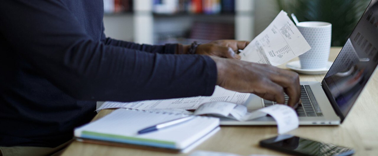 Business owner reviewing receipts while preparing taxes
