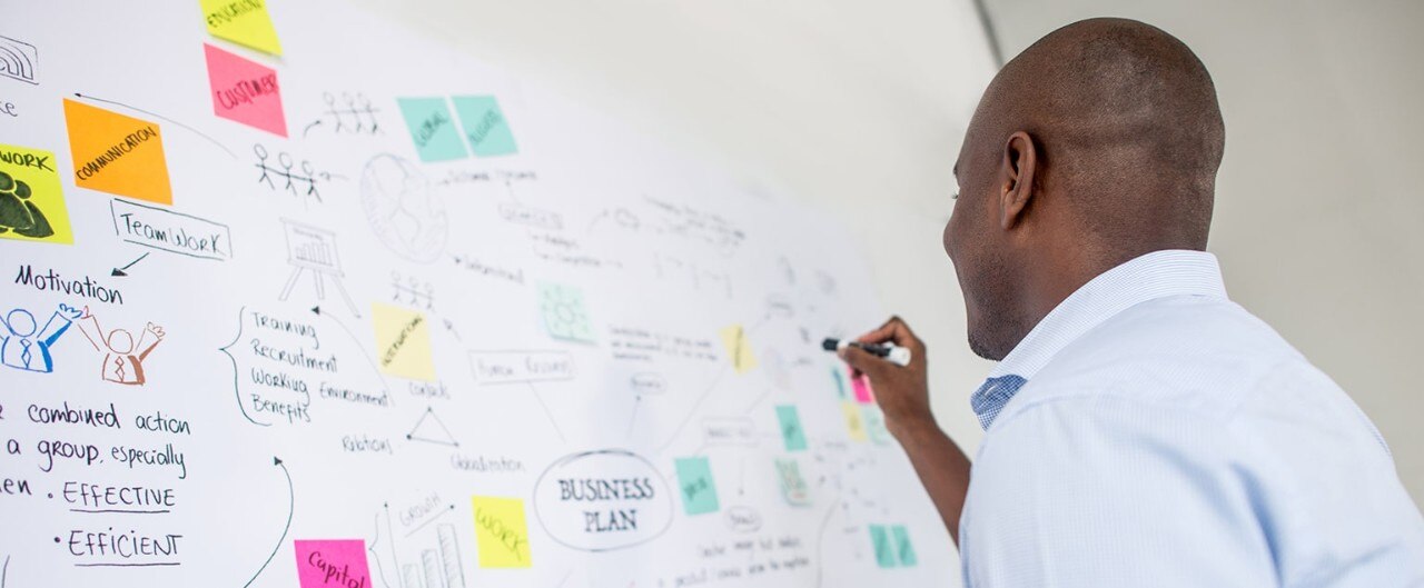 African-American business owner mapping out his business plan