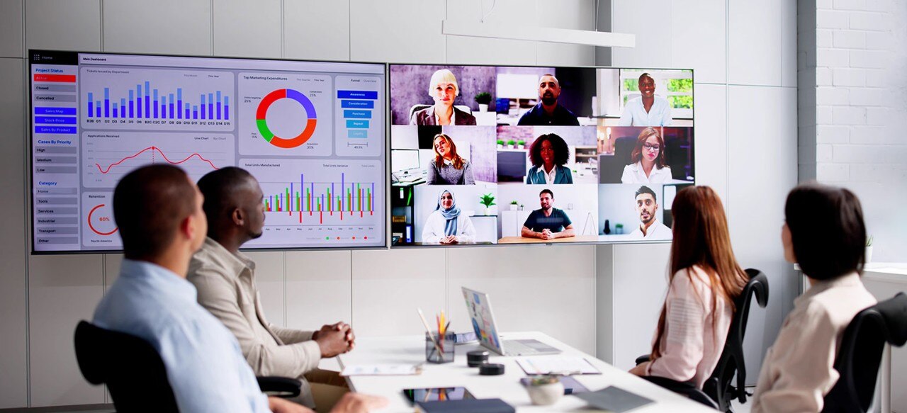 Businesspeople attending a video conference and hybrid presentation with international colleagues