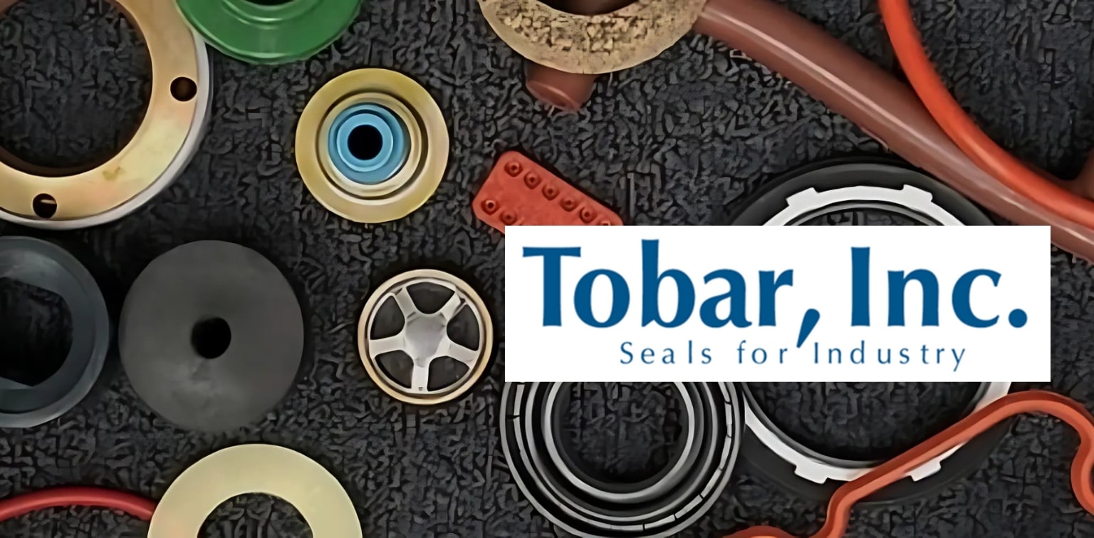 Industrial seals of different shapes and sizes arranged on a black carpet with and overlay of the logo of Tobar Inc. 