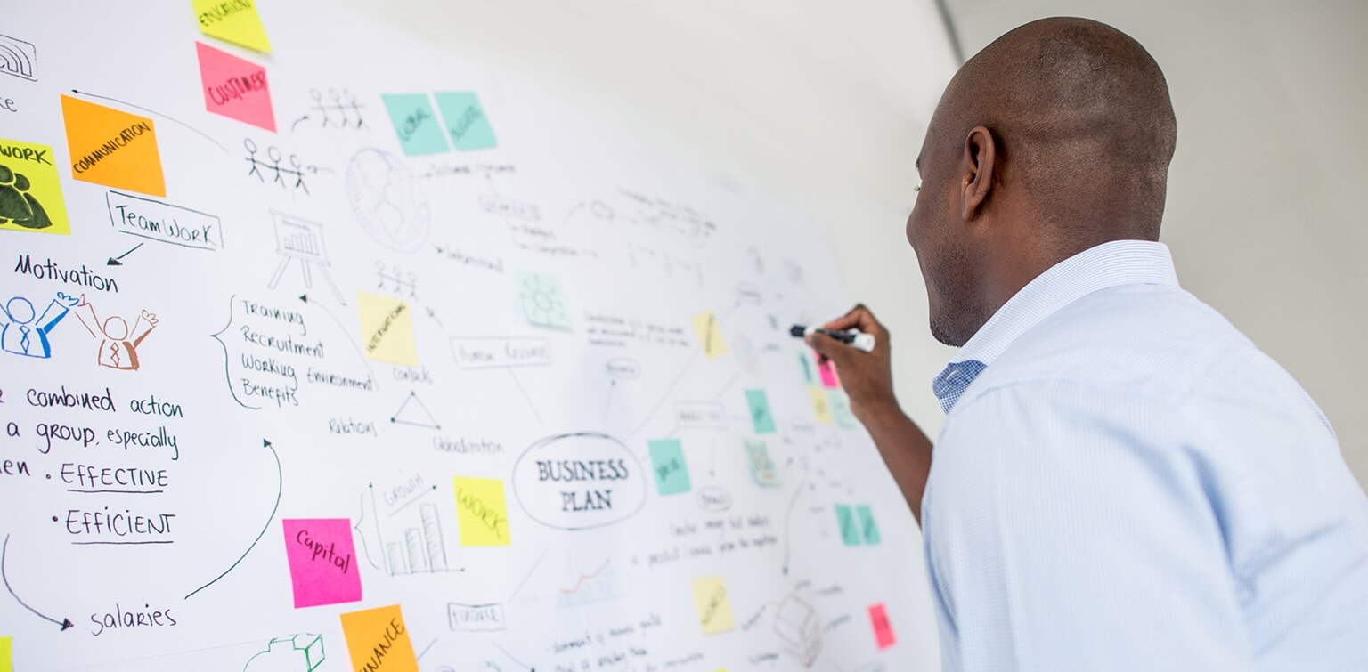 African-American business owner mapping out his business plan
