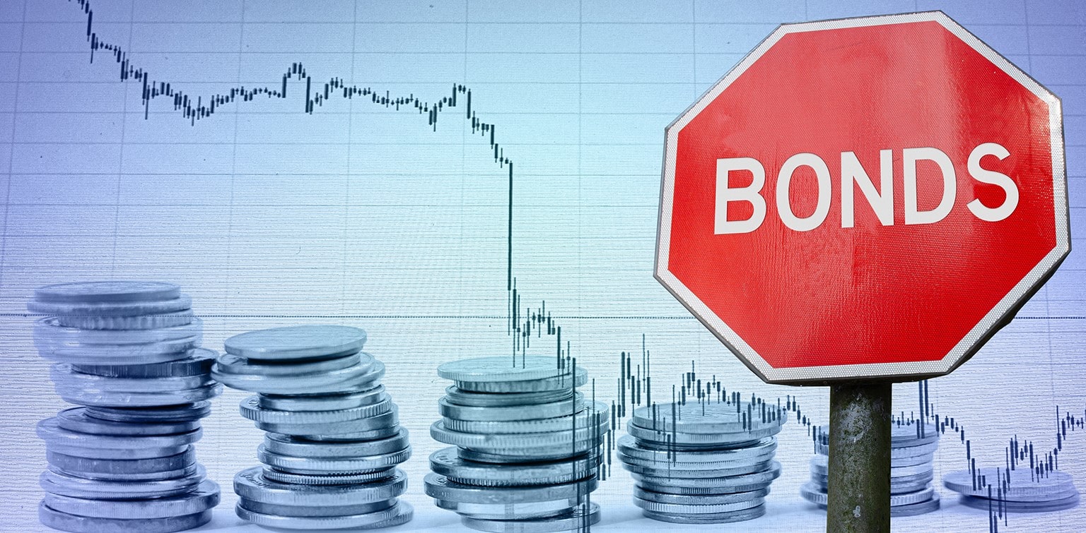 Stop sign labeled "Bonds" with coins and downward-trending graph in background