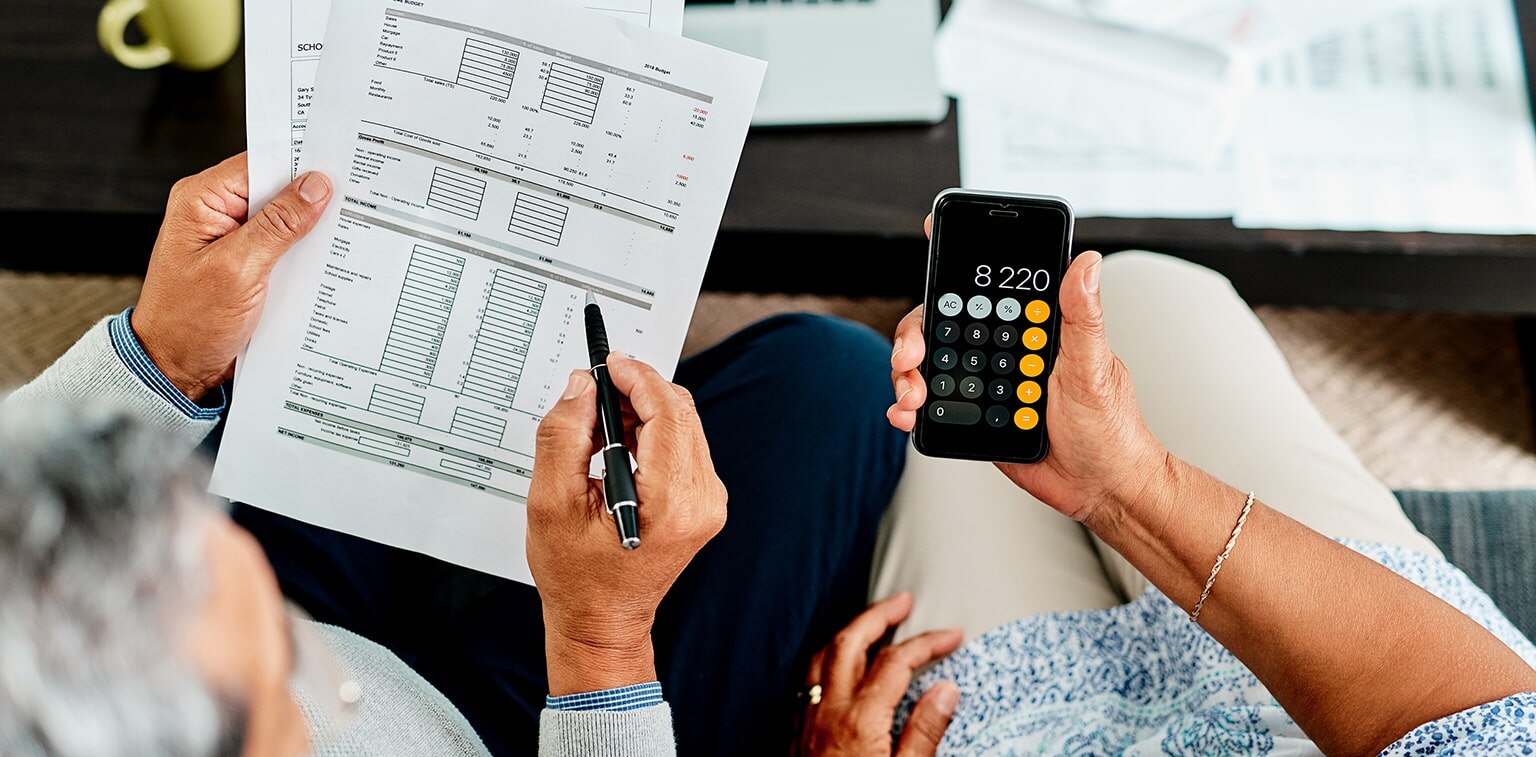 couple reviewing papers with calculator