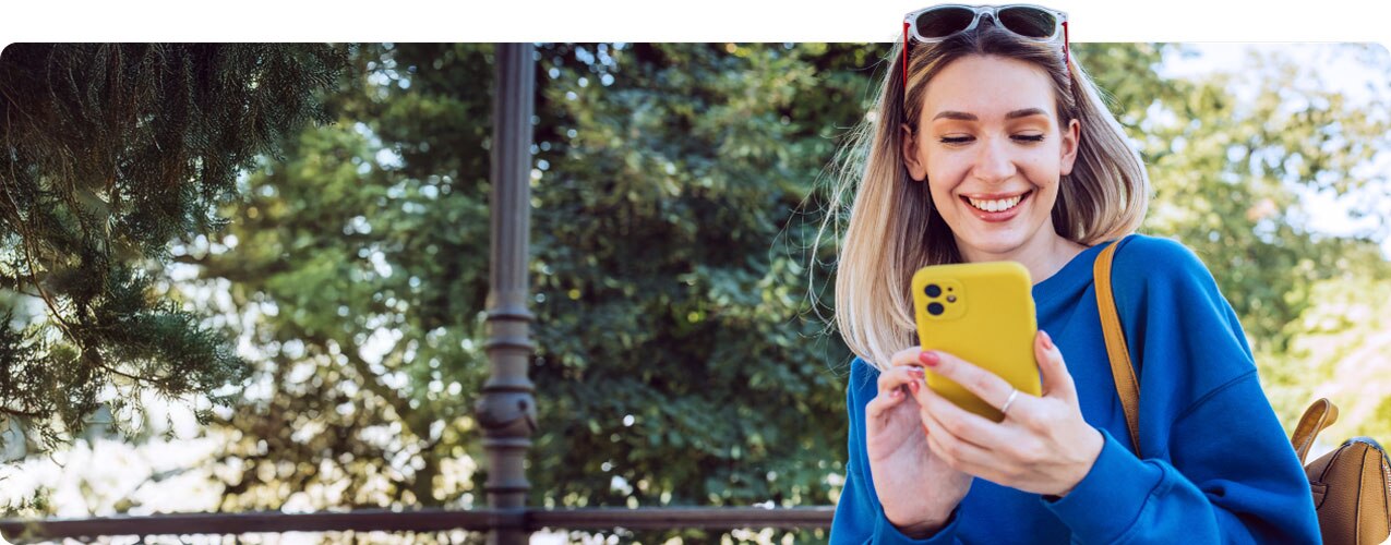 Smiling young woman using smartphone