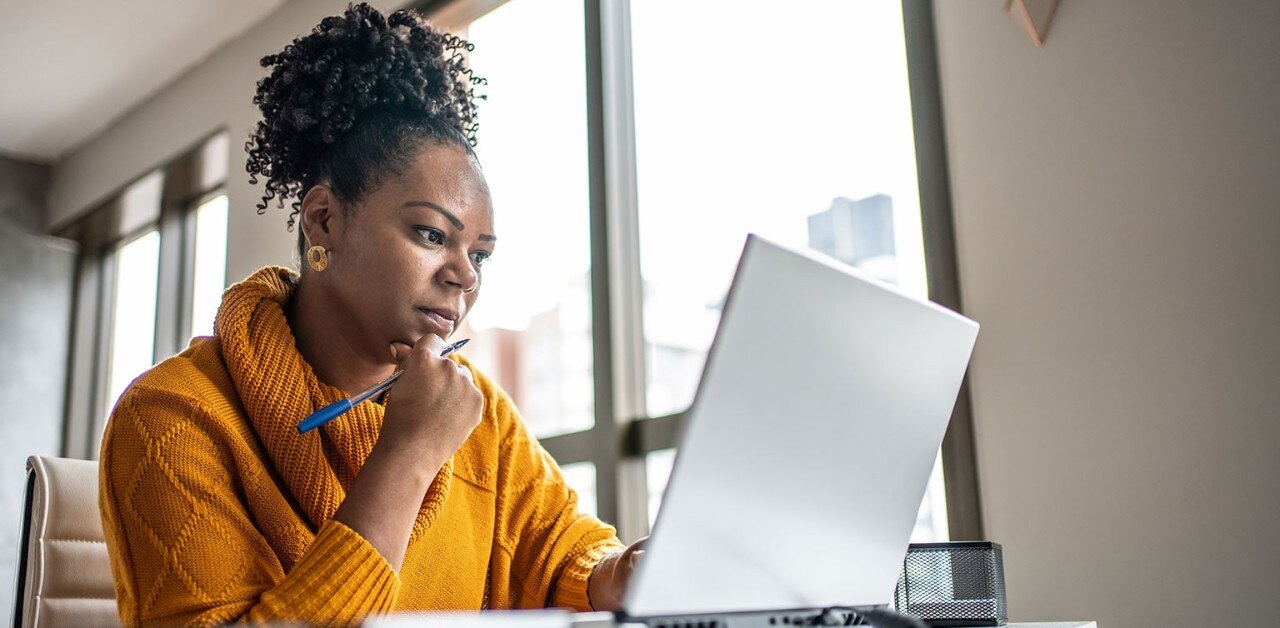 African-American woman looking at laptop