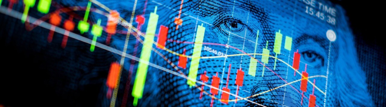 Red and green economic data points over close up image of Washington's portrait on $1 bill