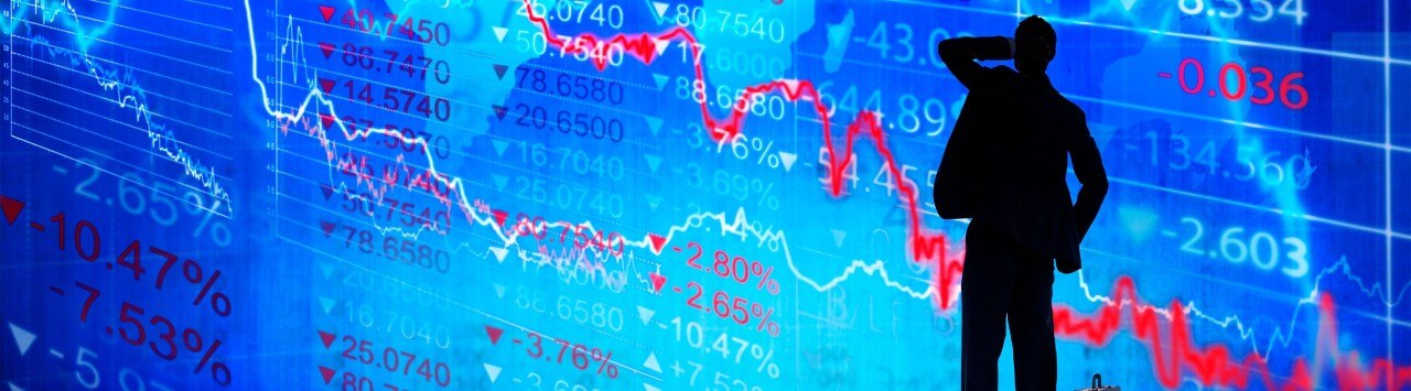 Silhouette of a man with stock market data in the background, suggesting market uncertainty