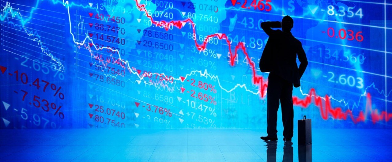 Silhouette of a man with stock market data in the background, suggesting market uncertainty