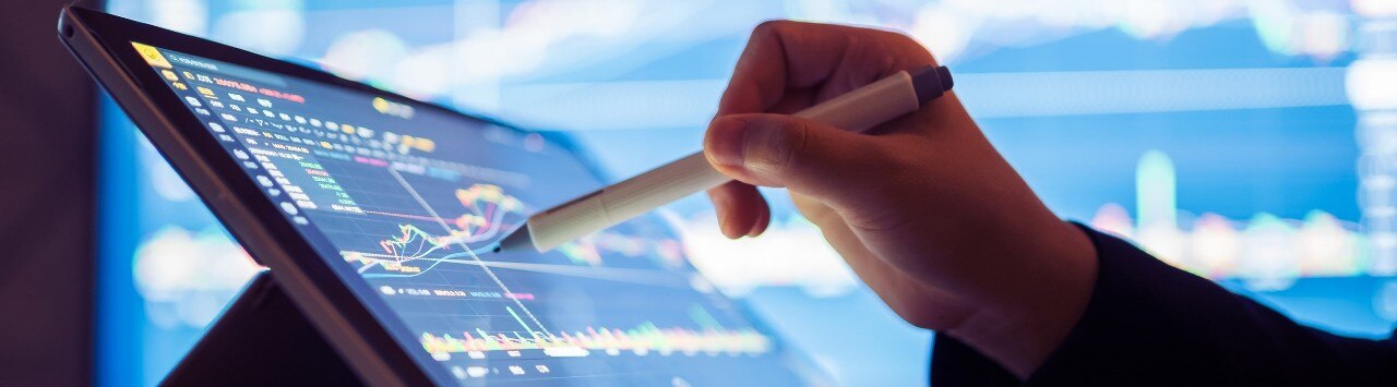 Financial professional reviewing stock data on tablet computer