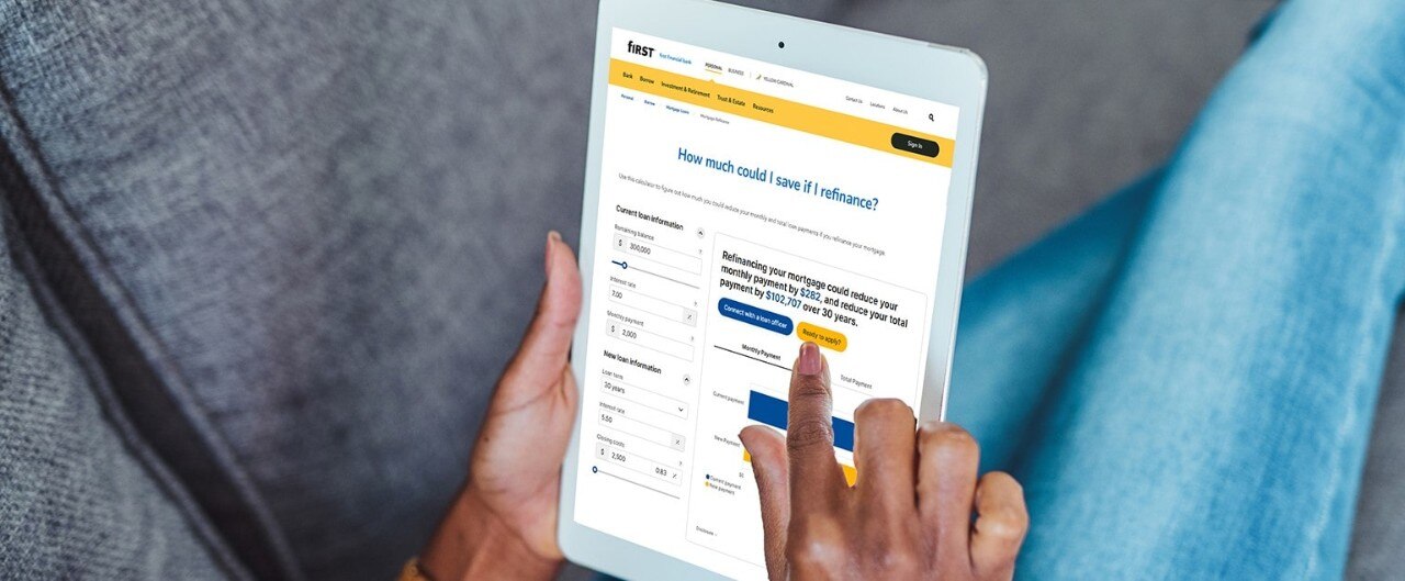 woman using tablet with digital refinancing calculator on the screen