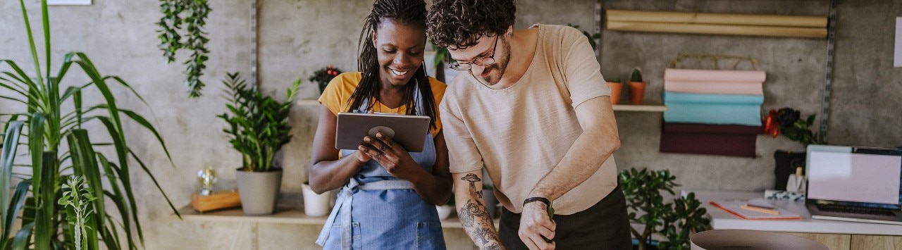 Multiracial business partners using tablet in florist shop