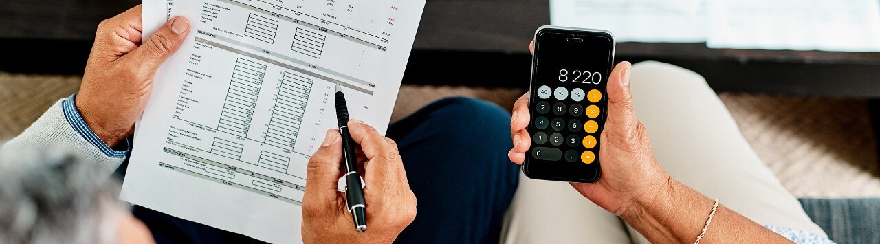 couple reviewing papers with calculator