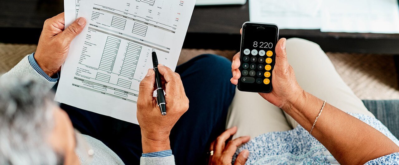 couple reviewing papers with calculator