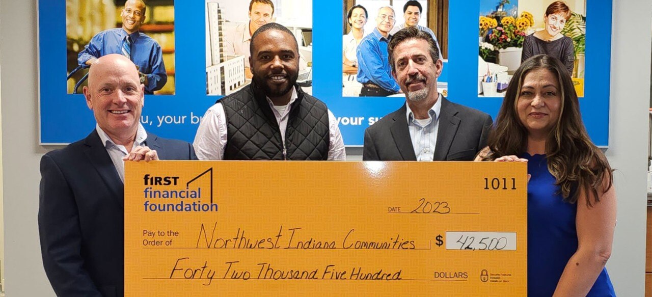 First Financial associates presenting a donation check to Northwest Indiana Communities