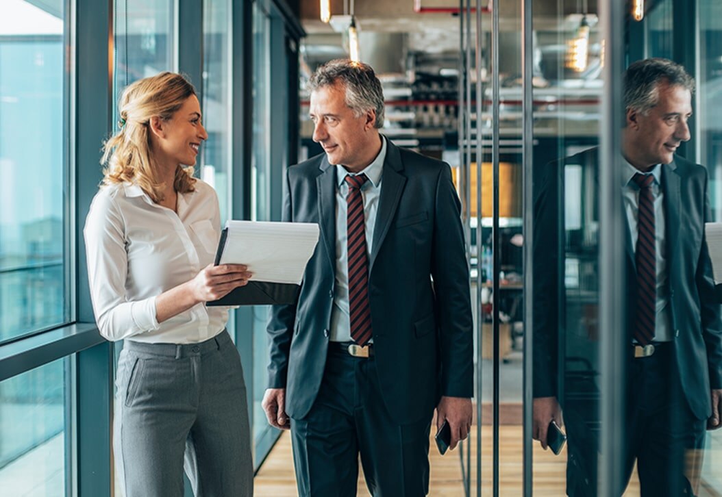 Smiling woman reviewing documents with male colleague