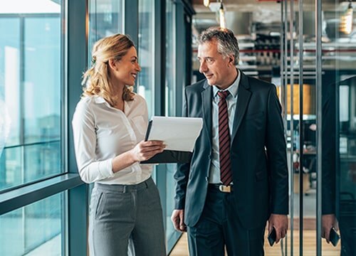 Smiling woman reviewing documents with male colleague