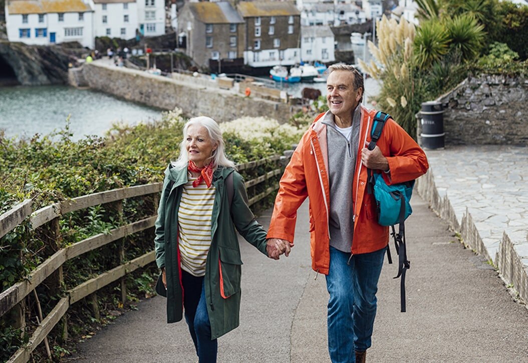 Senior couple holding hands and walking through a European city