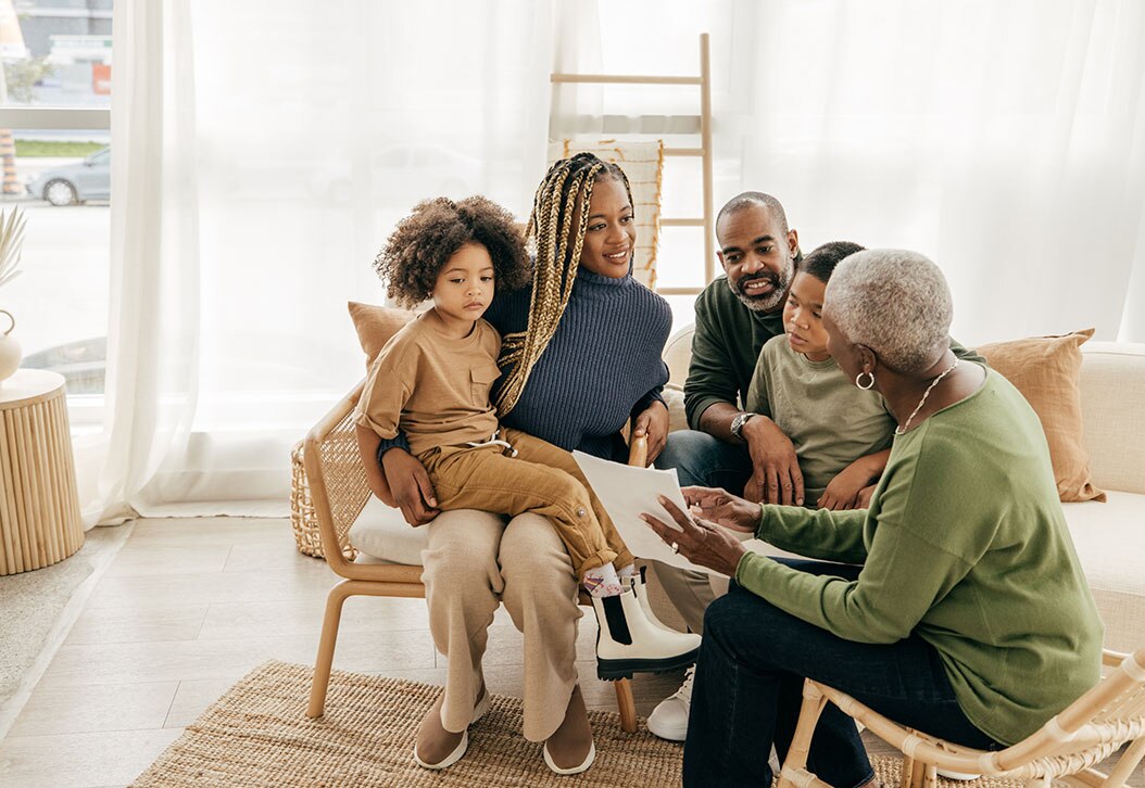Multi-generational African-American family reviewing financial documents