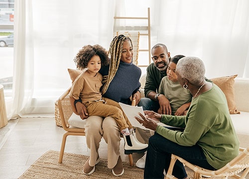 Multi-generational African-American family reviewing financial documents