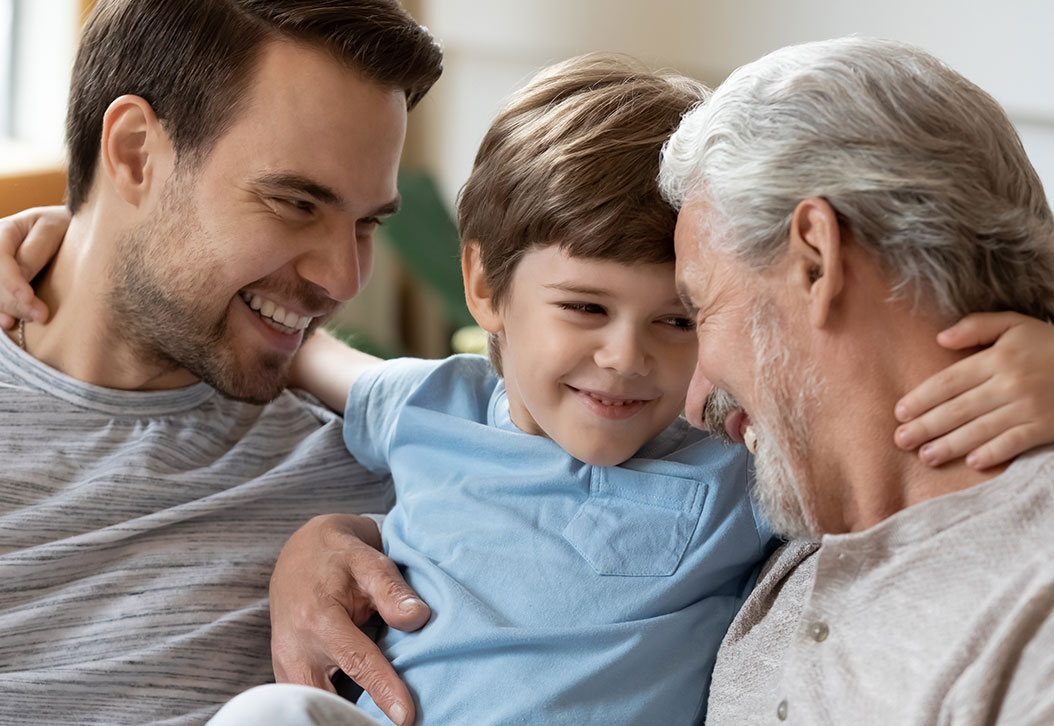 Father, son, and grandfather all embracing